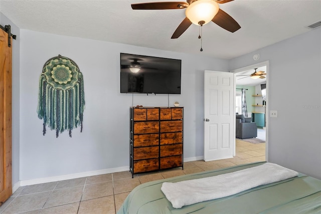 705 Ibis Ave, Deltona, FL 32738 - tiled bedroom with a barn door and a ceiling fan