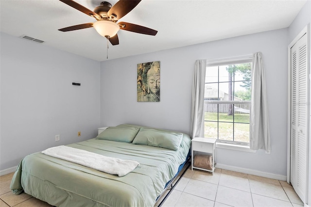 705 Ibis Ave, Deltona, FL 32738 - bedroom with light tile patterned flooring, a closet, and a ceiling fan