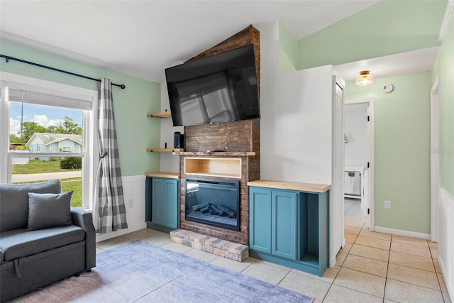 705 Ibis Ave, Deltona, FL 32738 - living area with lofted ceiling, light tile patterned floors, and a glass covered fireplace