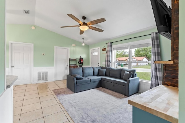 705 Ibis Ave, Deltona, FL 32738 - living area featuring vaulted ceiling, a ceiling fan, wainscoting, and light tile patterned floors
