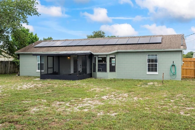 705 Ibis Ave, Deltona, FL 32738 - back of property featuring a sunroom, roof with shingles, and solar panels