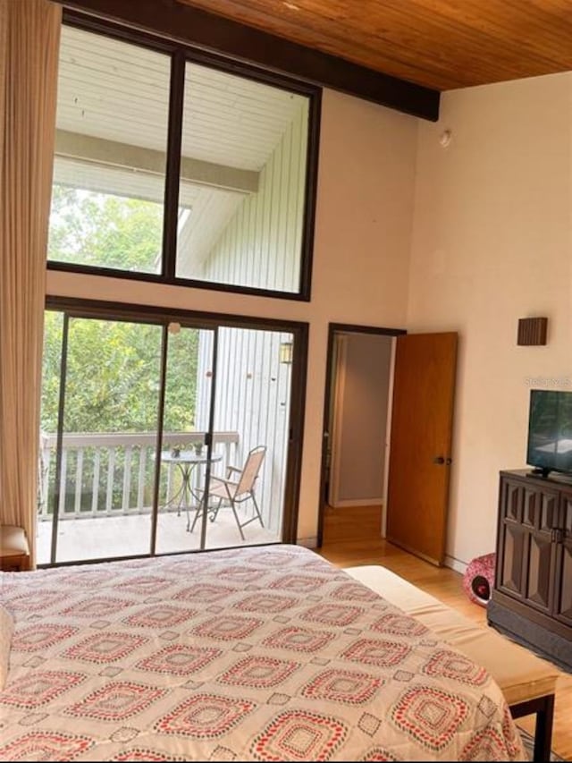116 Palm View Ct Unit 3535/6, Haines City, FL 33844 - bedroom with access to outside, a high ceiling, a wood ceiling with exposed beams, and light wood-style floors