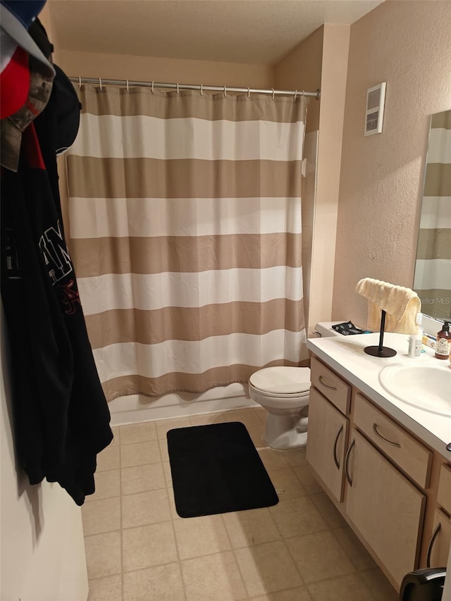 7230 Westpointe Blvd Unit 1235, Orlando, FL 32835 - full bath featuring a textured wall, vanity, a shower with curtain, and tile patterned floors