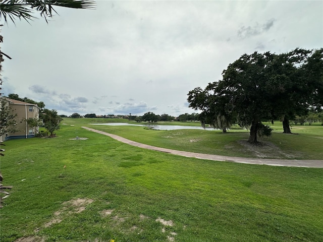 7230 Westpointe Blvd Unit 1235, Orlando, FL 32835 - surrounding community with a water view and a yard