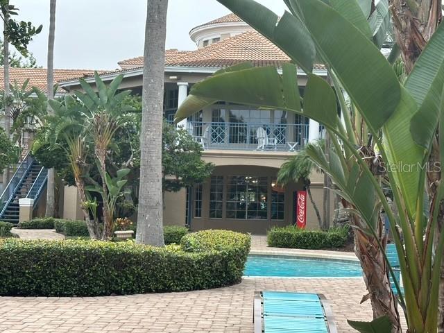 7230 Westpointe Blvd Unit 1235, Orlando, FL 32835 - community pool featuring a patio area