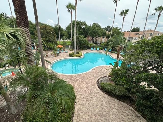 7230 Westpointe Blvd Unit 1235, Orlando, FL 32835 - community pool with a patio area