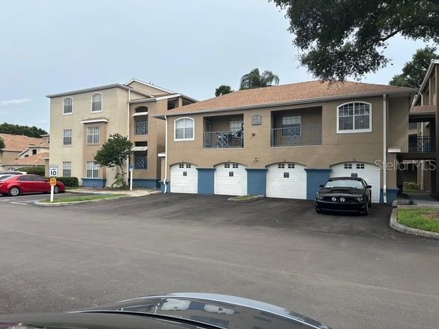 7230 Westpointe Blvd Unit 1235, Orlando, FL 32835 - view of building exterior with a garage and driveway