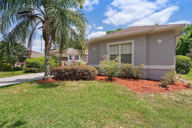 1542 Wescott Loop, Winter Springs, FL 32708 - view of front of home with stucco siding, a front lawn, and driveway