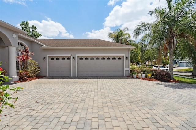 1542 Wescott Loop, Winter Springs, FL 32708 - view of front of home featuring decorative driveway, an attached garage, and stucco siding
