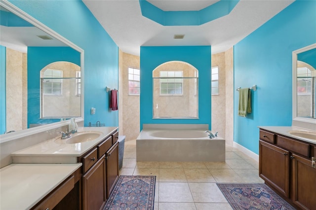 1542 Wescott Loop, Winter Springs, FL 32708 - bathroom featuring a garden tub, tile patterned flooring, healthy amount of natural light, and two vanities