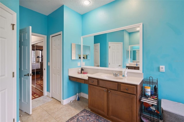 1542 Wescott Loop, Winter Springs, FL 32708 - full bath with vanity, tile patterned floors, a textured ceiling, and connected bathroom