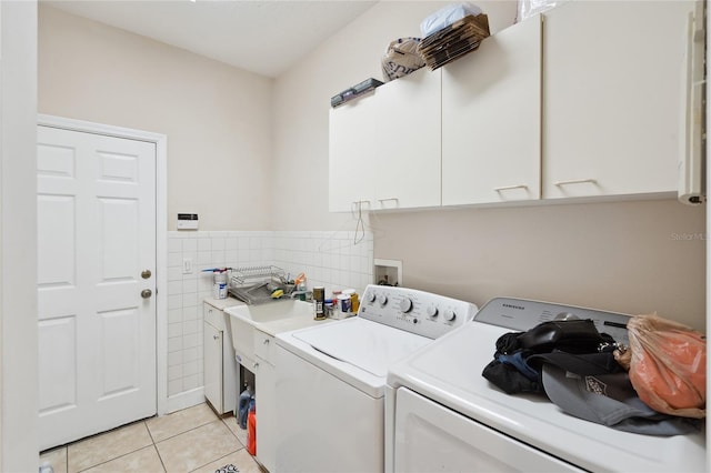 1542 Wescott Loop, Winter Springs, FL 32708 - washroom featuring cabinet space, independent washer and dryer, light tile patterned floors, tile walls, and a wainscoted wall