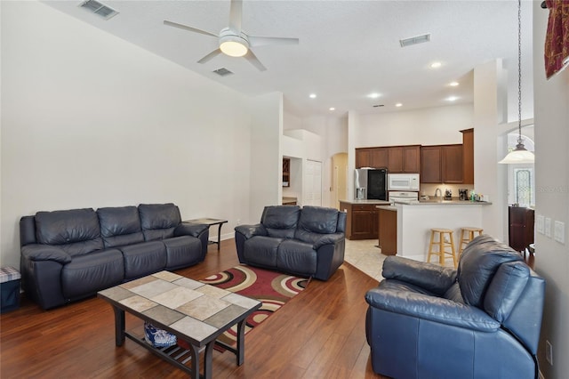 1542 Wescott Loop, Winter Springs, FL 32708 - living room featuring a towering ceiling, wood finished floors, ceiling fan, and recessed lighting