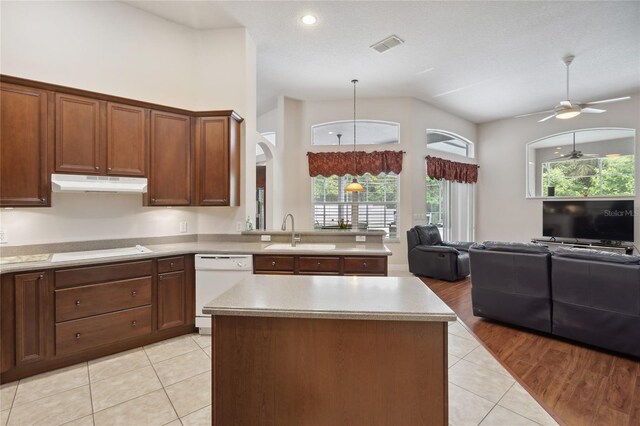 1542 Wescott Loop, Winter Springs, FL 32708 - kitchen with dishwasher, under cabinet range hood, arched walkways, open floor plan, and light tile patterned floors