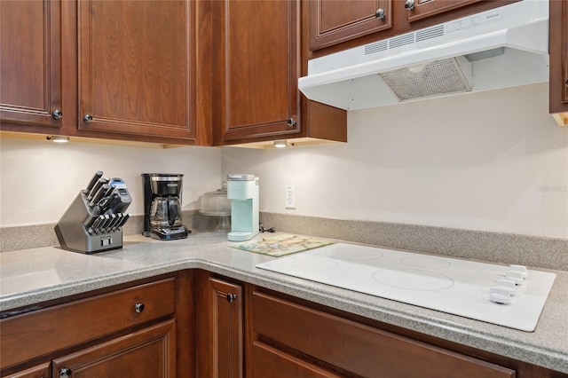 1542 Wescott Loop, Winter Springs, FL 32708 - kitchen with under cabinet range hood, white electric cooktop, and light countertops