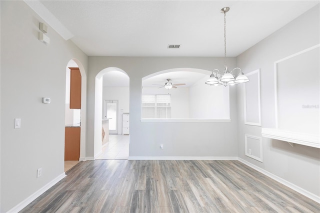 2211 J Lawson Blvd, Orlando, FL 32824 - unfurnished dining area featuring arched walkways, wood finished floors, and a ceiling fan