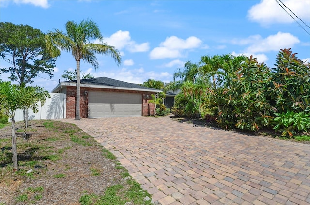 209 7th St S, Haines City, FL 33844 - view of front of home featuring brick siding, a garage, and driveway