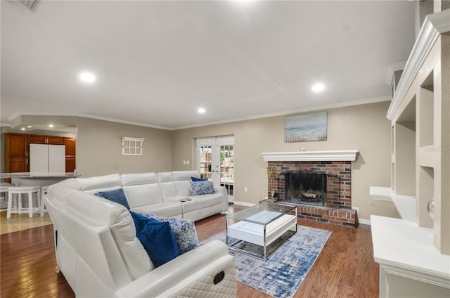209 7th St S, Haines City, FL 33844 - living area featuring ornamental molding, dark wood-style floors, recessed lighting, and a fireplace