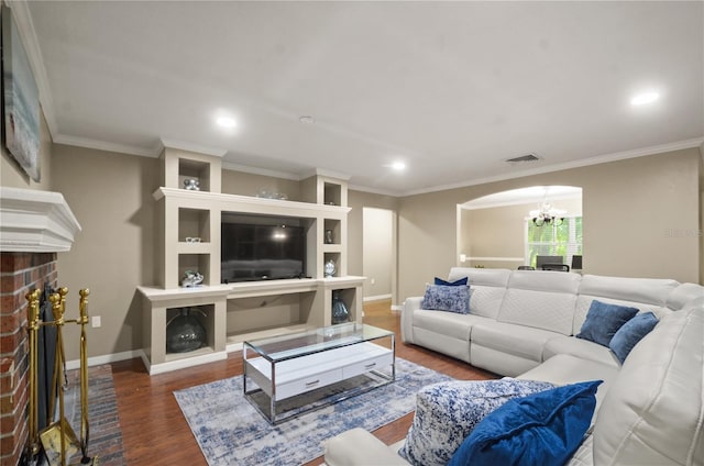 209 7th St S, Haines City, FL 33844 - living room with a chandelier, a fireplace, wood finished floors, recessed lighting, and ornamental molding