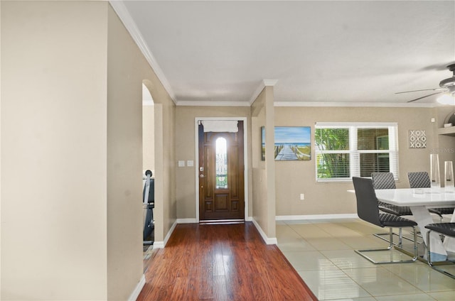 209 7th St S, Haines City, FL 33844 - foyer entrance featuring ornamental molding, ceiling fan, wood finished floors, and arched walkways
