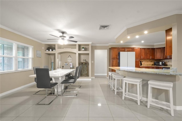 209 7th St S, Haines City, FL 33844 - dining room featuring ornamental molding, ceiling fan, light tile patterned flooring, and recessed lighting
