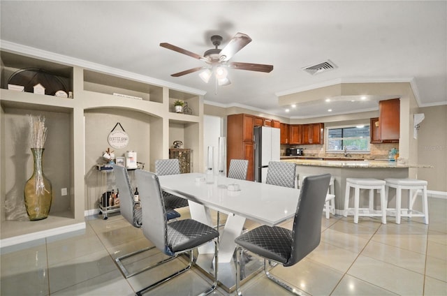 209 7th St S, Haines City, FL 33844 - dining space with crown molding, light tile patterned floors, a ceiling fan, recessed lighting, and built in features