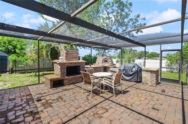 209 7th St S, Haines City, FL 33844 - fenced backyard with an outdoor stone fireplace, a patio area, a grill, and glass enclosure