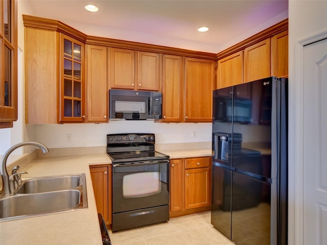 17322 Chateau Pine Way, Clermont, FL 34711 - kitchen featuring black appliances, light countertops, brown cabinets, light tile patterned flooring, and recessed lighting