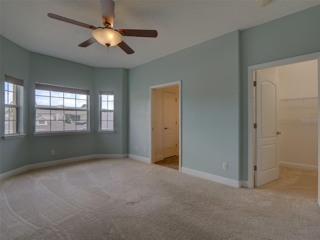 17322 Chateau Pine Way, Clermont, FL 34711 - unfurnished bedroom with carpet flooring, a walk in closet, and ceiling fan