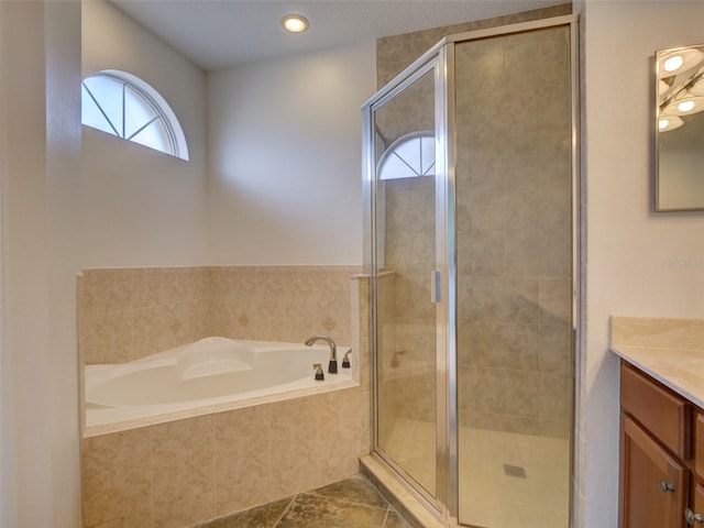 17322 Chateau Pine Way, Clermont, FL 34711 - full bath featuring vanity, a garden tub, a shower stall, and tile patterned flooring