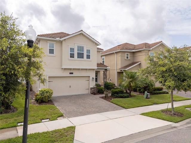 1097 Trappers Trail Loop, Davenport, FL 33896 - view of front of home with a tile roof, driveway, an attached garage, a front lawn, and stucco siding