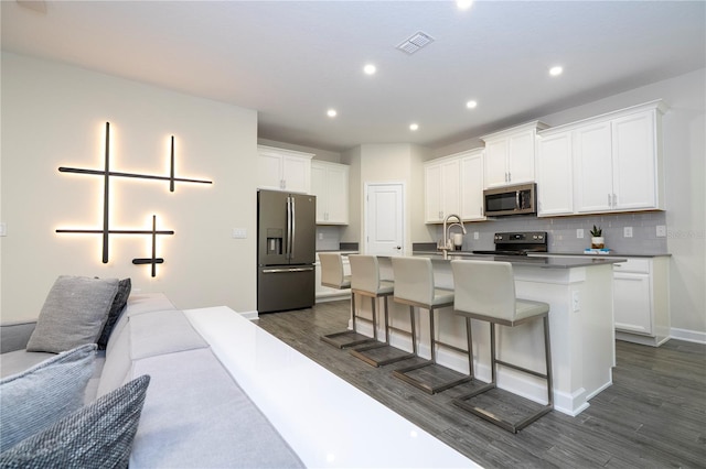 1097 Trappers Trail Loop, Davenport, FL 33896 - kitchen featuring appliances with stainless steel finishes, dark wood-type flooring, white cabinets, and recessed lighting
