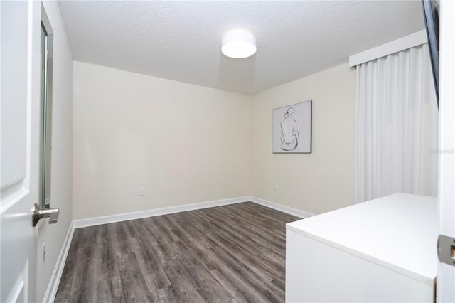 1097 Trappers Trail Loop, Davenport, FL 33896 - empty room with dark wood finished floors and a textured ceiling