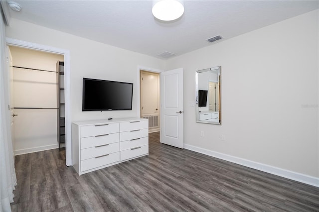 1097 Trappers Trail Loop, Davenport, FL 33896 - unfurnished bedroom featuring dark wood-type flooring and a spacious closet