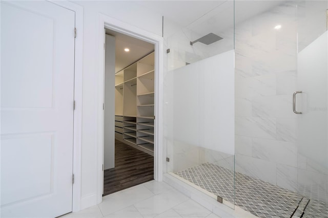 1097 Trappers Trail Loop, Davenport, FL 33896 - full bathroom featuring a shower stall, marble look tiles, and a walk in closet