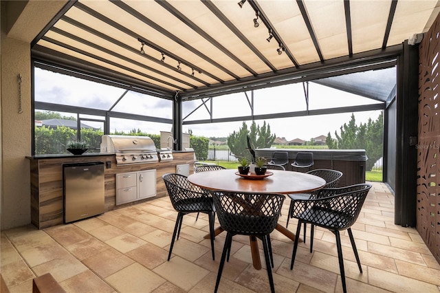 1097 Trappers Trail Loop, Davenport, FL 33896 - view of patio / terrace featuring a hot tub, exterior kitchen, glass enclosure, and outdoor dining area