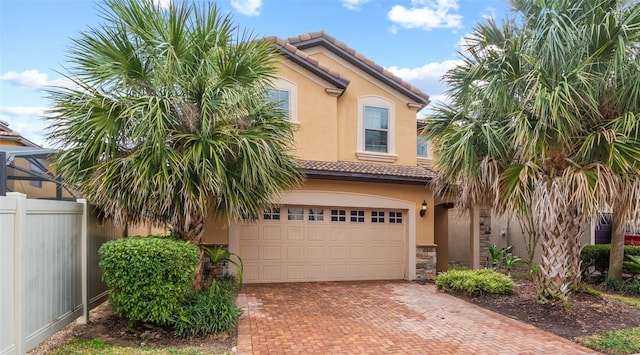 2121 Morocco Way, Kissimmee, FL 34747 - view of front of house with stucco siding, a tile roof, an attached garage, and decorative driveway
