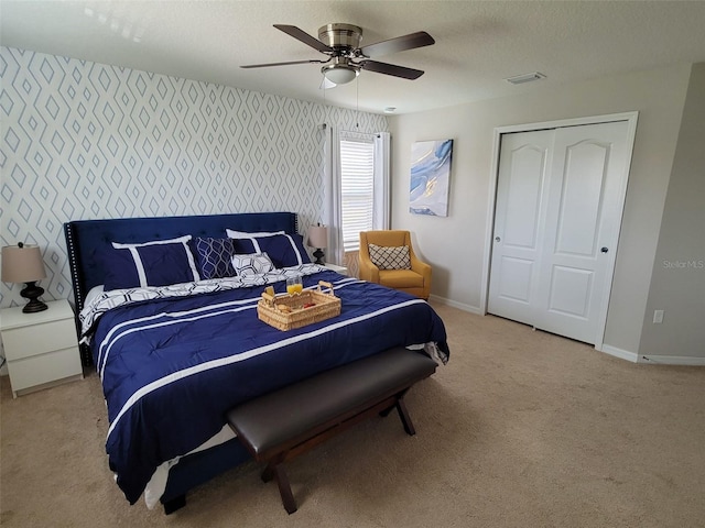 2121 Morocco Way, Kissimmee, FL 34747 - bedroom with wallpapered walls, light carpet, and ceiling fan