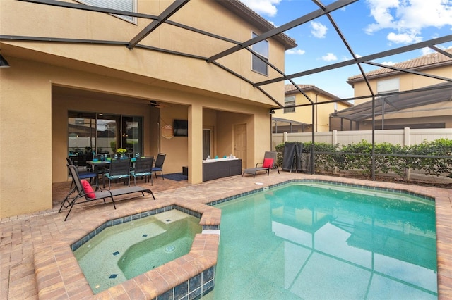 2121 Morocco Way, Kissimmee, FL 34747 - view of pool featuring a patio area, glass enclosure, a pool with connected hot tub, and outdoor dining area
