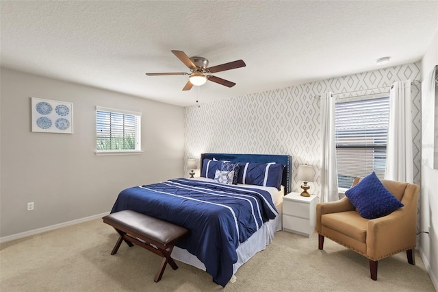 2121 Morocco Way, Kissimmee, FL 34747 - bedroom featuring light colored carpet, a ceiling fan, wallpapered walls, and a textured ceiling