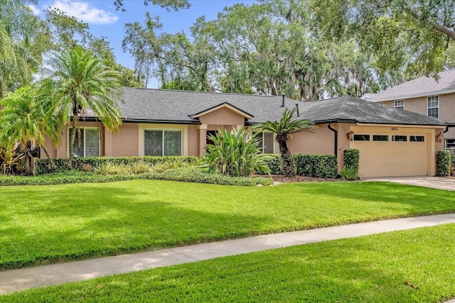 9275 Lake Sharp Ct, Orlando, FL 32817 - view of front facade featuring an attached garage, a front lawn, stucco siding, concrete driveway, and a shingled roof