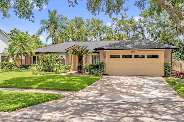 9275 Lake Sharp Ct, Orlando, FL 32817 - single story home featuring an attached garage, stucco siding, a front lawn, and driveway