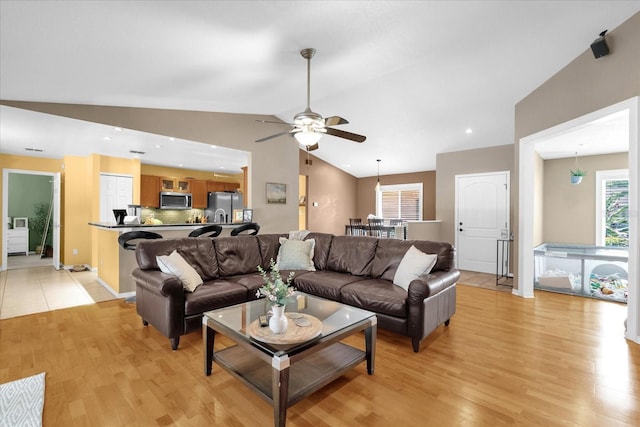 9275 Lake Sharp Ct, Orlando, FL 32817 - living area featuring lofted ceiling, light wood finished floors, and a ceiling fan