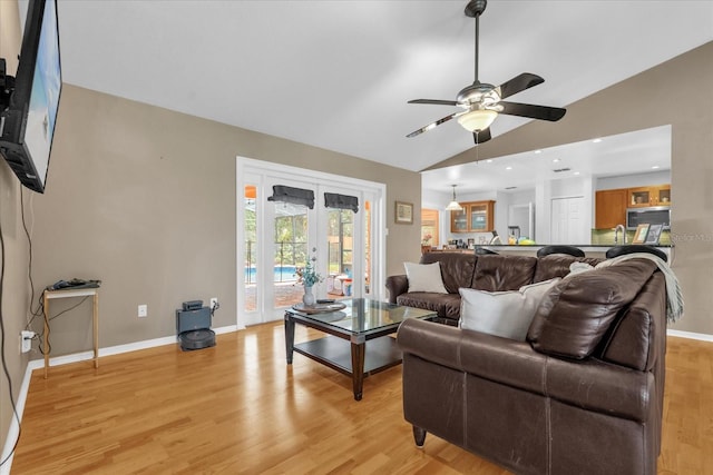 9275 Lake Sharp Ct, Orlando, FL 32817 - living area with light wood-style flooring, vaulted ceiling, french doors, and ceiling fan
