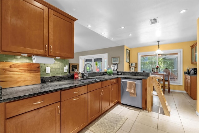 9275 Lake Sharp Ct, Orlando, FL 32817 - kitchen featuring dishwasher, a peninsula, decorative backsplash, brown cabinets, and light tile patterned floors