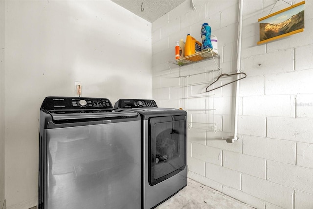 9275 Lake Sharp Ct, Orlando, FL 32817 - laundry room featuring separate washer and dryer and concrete block wall