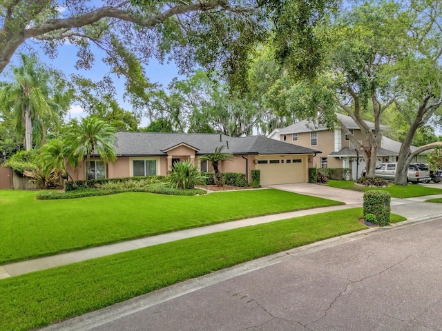 9275 Lake Sharp Ct, Orlando, FL 32817 - view of front of house featuring an attached garage, stucco siding, concrete driveway, and a front yard