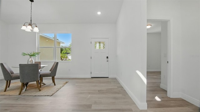 17 Cypress Run, Haines City, FL 33844 - foyer entrance featuring light wood finished floors, a chandelier, and recessed lighting