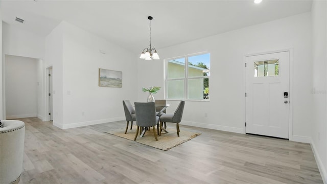 17 Cypress Run, Haines City, FL 33844 - dining space featuring light wood finished floors and a chandelier