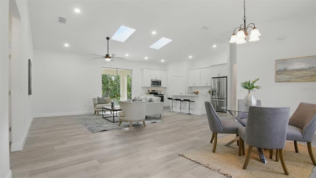 17 Cypress Run, Haines City, FL 33844 - dining area with light wood-style floors, a skylight, ceiling fan, recessed lighting, and high vaulted ceiling